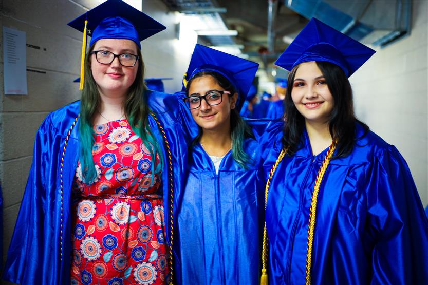 A group of graduates wearing blue robes